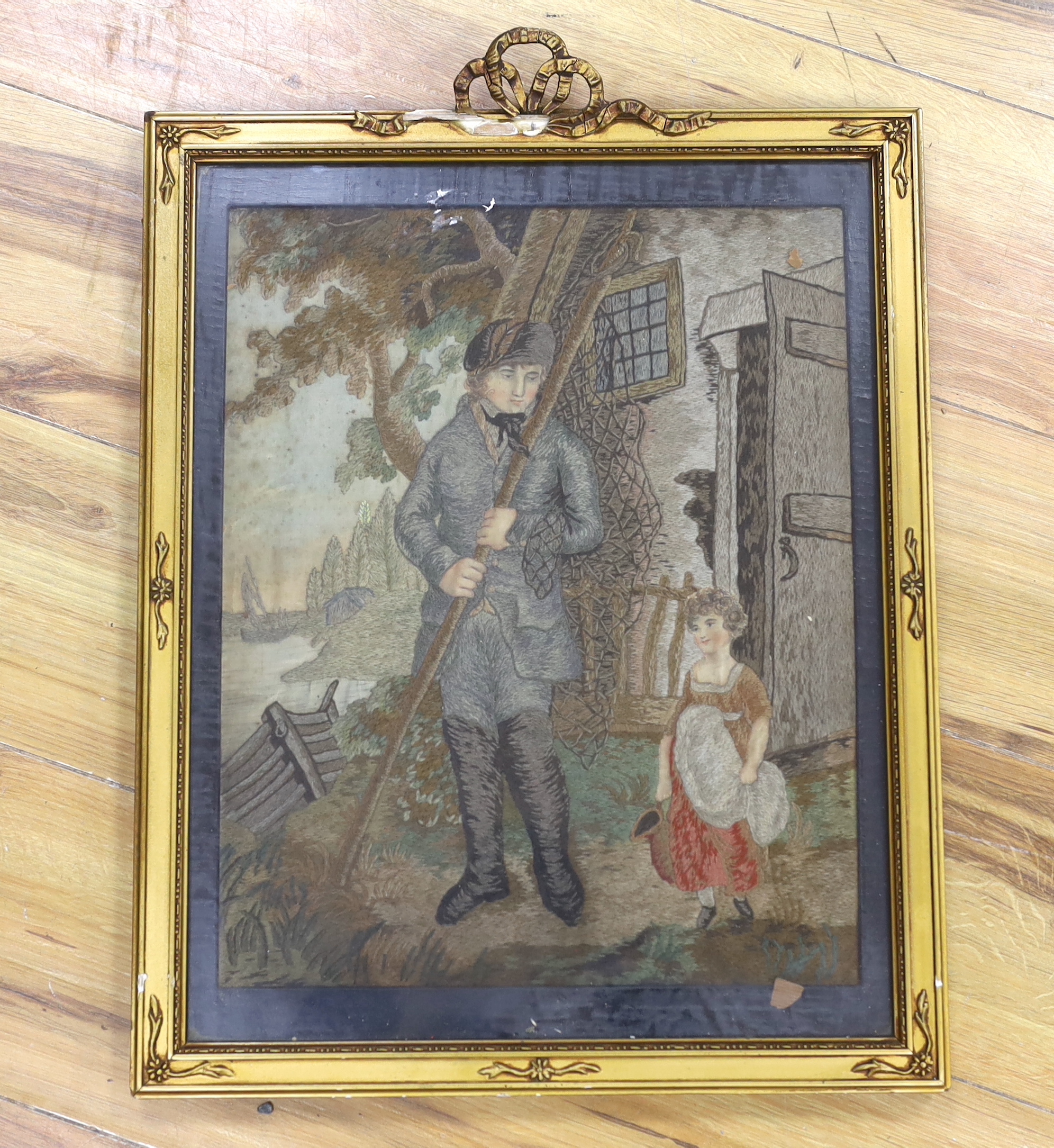 A late Georgian woolwork on silk picture depicting a fisherman and girl, 38x31cm excluding frame